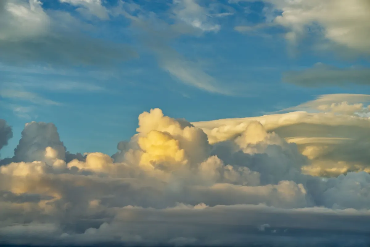 A stunning view of cumulus clouds against a bright blue sky, showcasing nature's beauty.