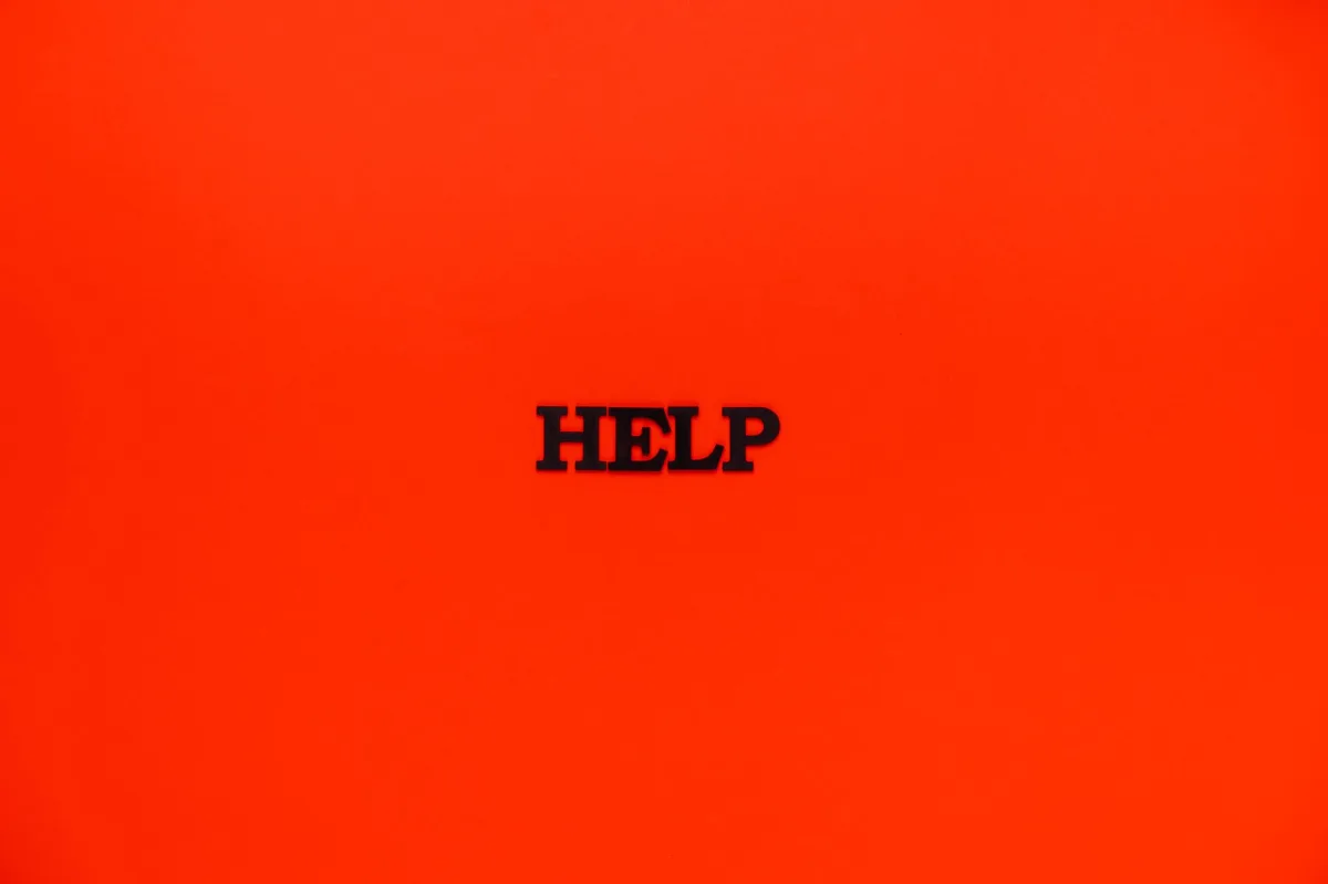 Minimalist red background featuring the word 'HELP' in bold text.